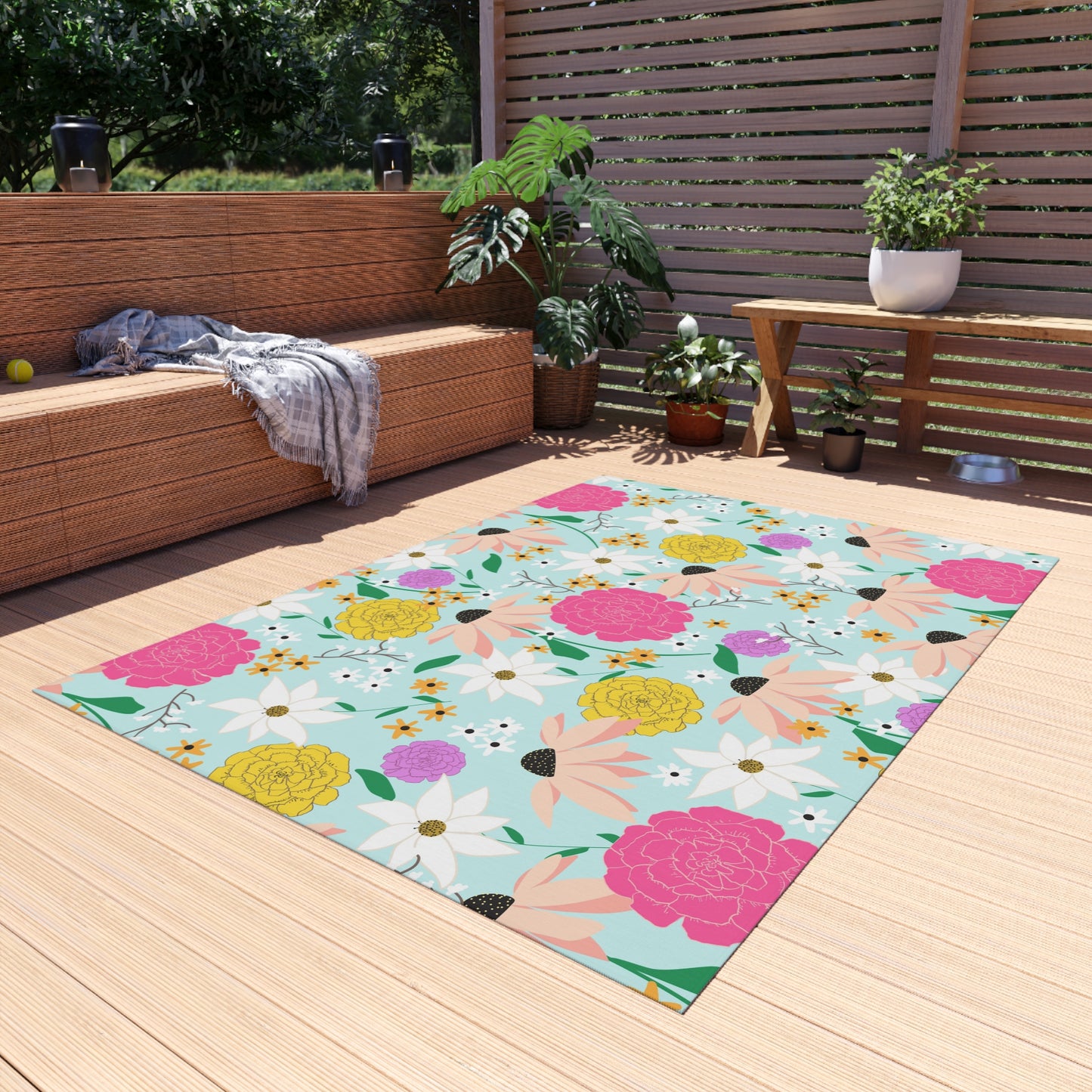A colorful outdoor patio rug featuring a vibrant floral pattern with pink, yellow, and white flowers on a soft aqua background. Designed for patios, decks, and garden spaces, this weather-resistant rug adds a lively, nature-inspired touch to any outdoor setting.