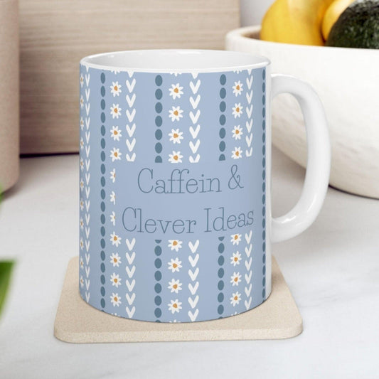 funny blue and white floral mug with typography "Caffein and Clever Ideas".