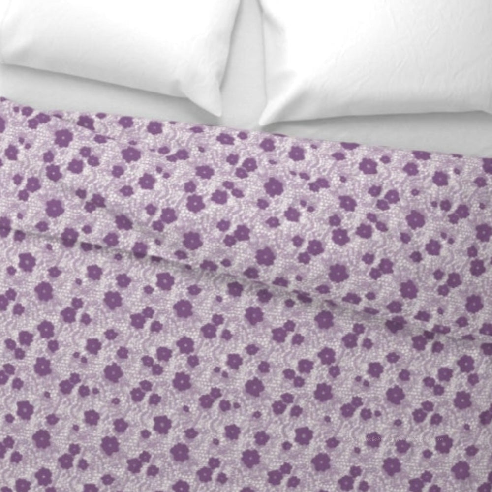 Lavender Flower Duvet Cover. This delicate design mimics vintage lacework with purple floral silhouettes scattered across a lavender Lace