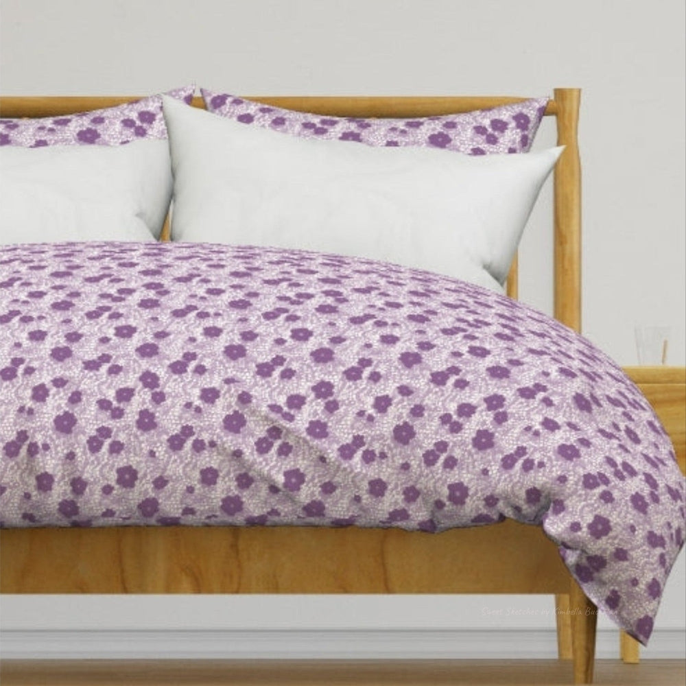 Lavender Flower Duvet Cover. This delicate design mimics vintage lacework with purple floral silhouettes scattered across a lavender Lace